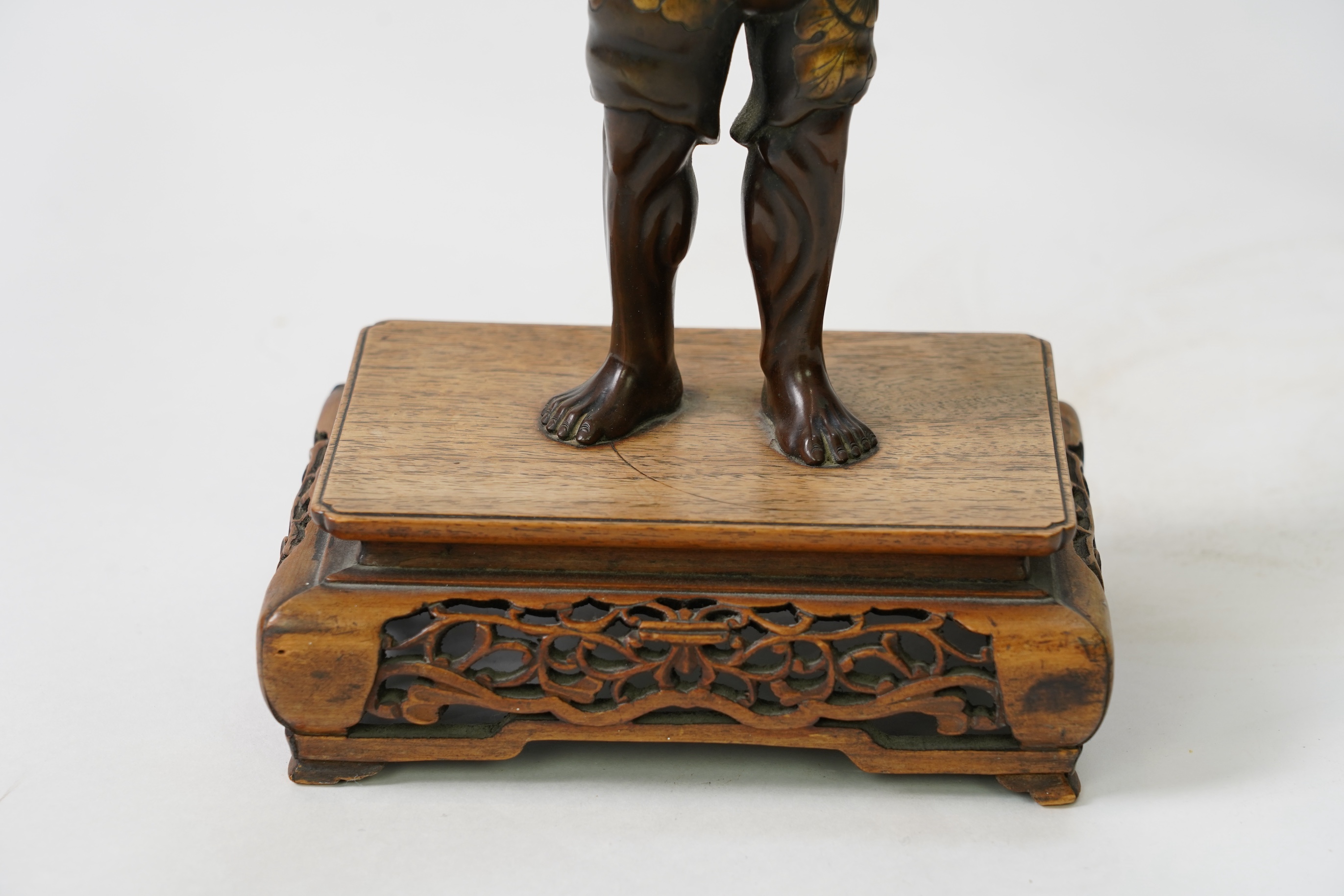 A Japanese bronze figure of an Oni holding a temple bell aloft, Meiji period, in Miyao style